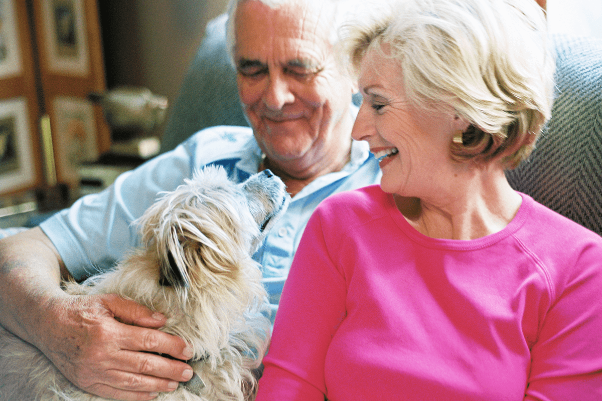 senior couple on couch with dog hospice marketing agency raleigh nc